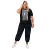 Plus-size model in black t-shirt with art.