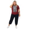 Woman in maroon shirt with artwork.