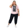Plus-size model in pink graphic tee.