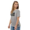 Woman in grey t-shirt with artwork.