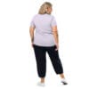 Woman in lavender shirt and black pants.