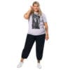 Woman in lavender t-shirt with art print.