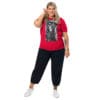 Plus-size model in red shirt, black pants.