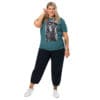 Plus-size model in teal shirt with art.