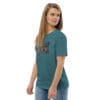 Woman wearing teal t-shirt with artwork.