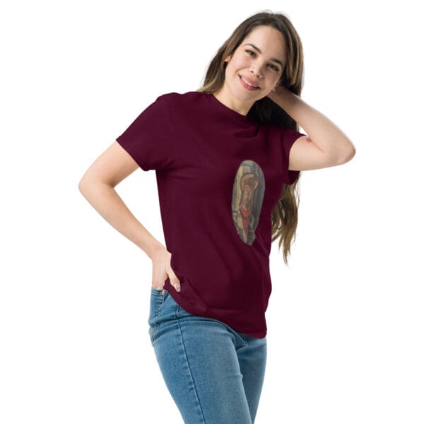 Woman in maroon t-shirt with artwork.