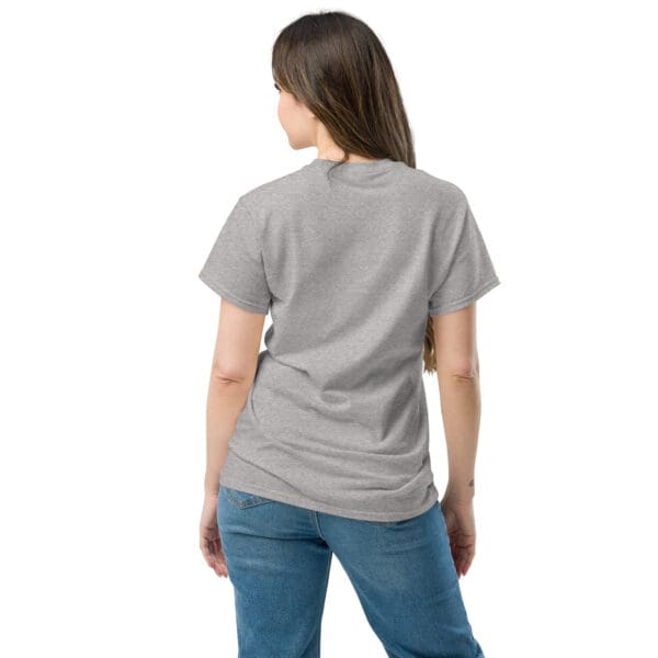 Woman in grey shirt, jeans, back view.