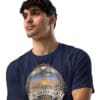 Man in navy The Golden Light T-shirt.