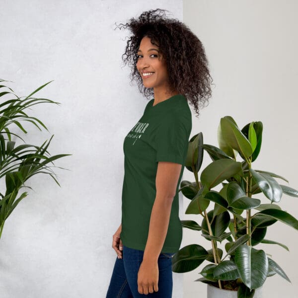 Woman in dark green shirt with text.