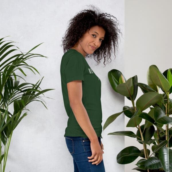 Woman in dark green shirt with text.