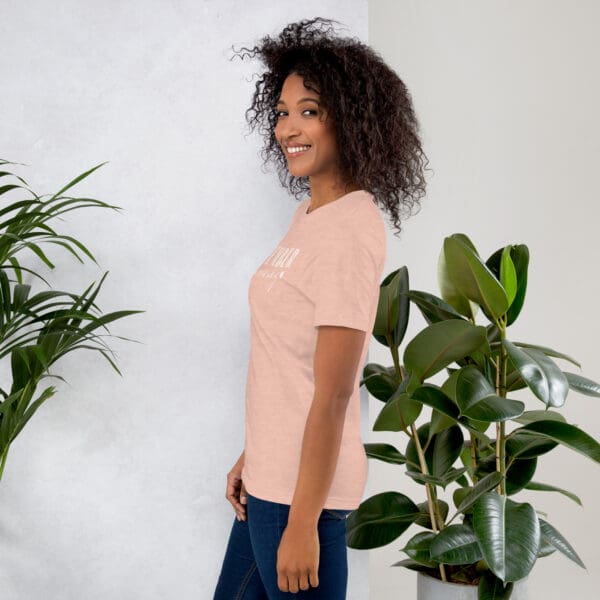 Woman in peach t-shirt, side view.