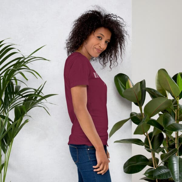 Woman in maroon t-shirt, side view.