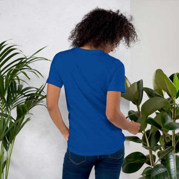 Woman in royal blue t-shirt, back view.