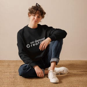 Person sitting wearing "on demand greatness" sweatshirt.