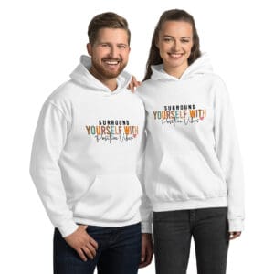 Two people wearing matching hoodies, smiling.