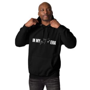 Man adjusting black hoodie with slogan