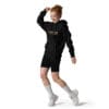 Woman in black hoodie and shorts dancing.
