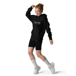 Woman in black hoodie and shorts dancing.