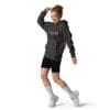 Young woman in hoodie dancing joyfully.