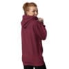 Woman smiling in a maroon hoodie.