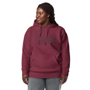 Woman wearing maroon hoodie with motivational text.
