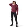 Person in a burgundy hoodie and black jeans.