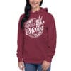Woman smiling in maroon hoodie with design.