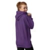Woman wearing a purple hoodie, looking back.