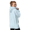 Woman smiling in light blue hoodie.