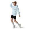 Woman in a light blue hoodie dancing.
