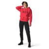 Woman in red hoodie and black pants.