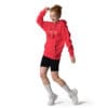 Person wearing a red hoodie and shorts.
