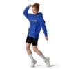 Woman in blue hoodie dancing joyfully.